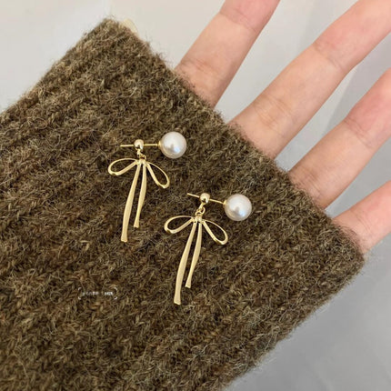 925 Silver Needle Korean and Japanese Summer Faux Pearl Bowknot Earrings Simple French Style Versatile 2026 New Women's Earrings