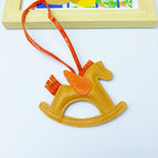 earthy yellow rocking horse bag pendant