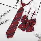 Burgundy badge (tie + collar flower)