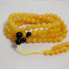 Old honey 108 necklace, approximately 70cm in length, with beads sized around 6-7mm, and weighing approximately 17.2g