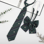Dark green badge (tie + collar flower)