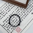 Single bell black bracelet