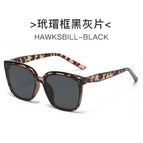 Tortoiseshell framed black and gray pieces