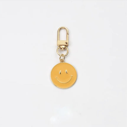 Cross-border e-commerce alloy color dripping smiley face keychain electroplated gold irregular expression bag pendant accessories