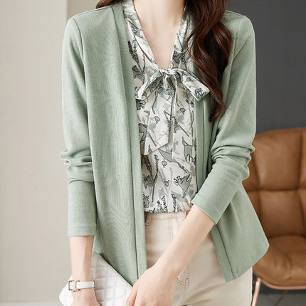 In the spring of 2025, the new style fake two-piece sweater women's design is small and chic green top.