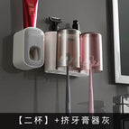 2 cups gray and white toothpaste squeezer