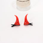 a pair of red hairpins