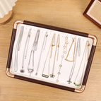 Off-white necklace plate with golden rounded corners