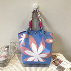 Blue background seven-petal flower handbag