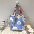 Handbag with beige background and blue flowers