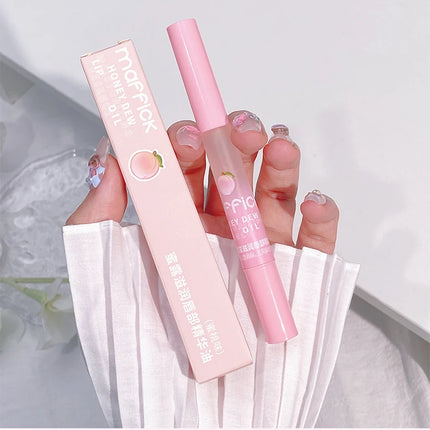 Peach Lip Oil, enriched with plant-based squalane, contains vitamin E and glycerin for long-lasting hydration and soft lips.