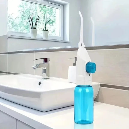 Portable high-pressure oral irrigator - manual tooth cleaner with grip, nozzle attachment for gum health
