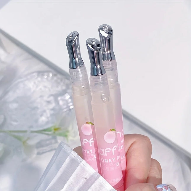 Peach Lip Oil, enriched with plant-based squalane, contains vitamin E and glycerin for long-lasting hydration and soft lips.