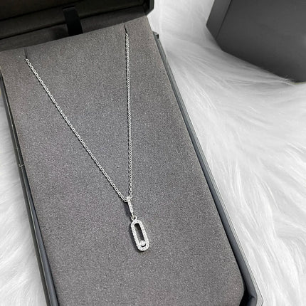 Minimalist long oval zircon pendant necklace with delicate tassel chain; stylish everyday party accessory.