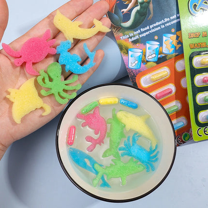12pcs/set Creative Soaking Water Expands To Large Sponge Capsule Toys Dinosaur Sea Animal Shape Kids Bath Swimming Puzzle Toys