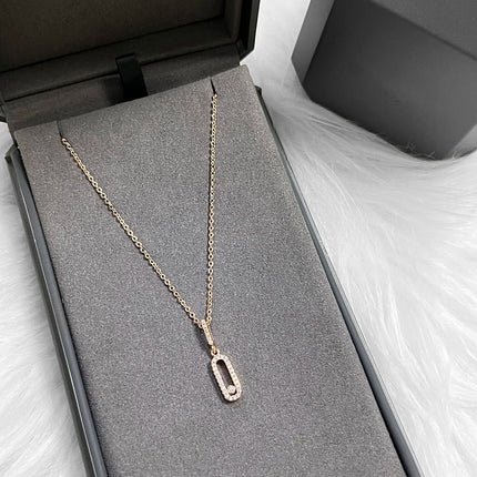Minimalist long oval zircon pendant necklace with delicate tassel chain; stylish everyday party accessory.