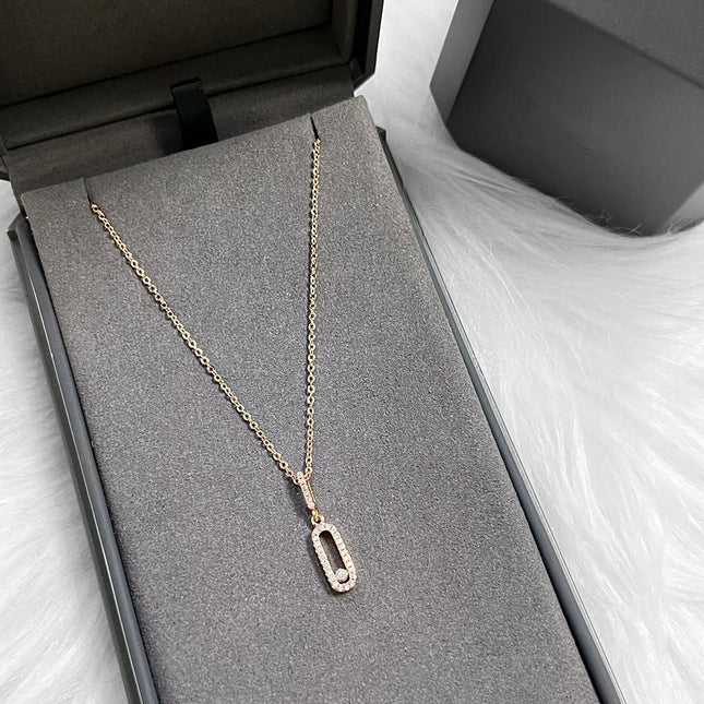 Minimalist long oval zircon pendant necklace with delicate tassel chain; stylish everyday party accessory.